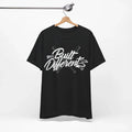 Black t-shirt with 'Built Different' text on a hanger against a white background