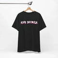 Black t-shirt with 'Built Different' text on a hanger against a white background