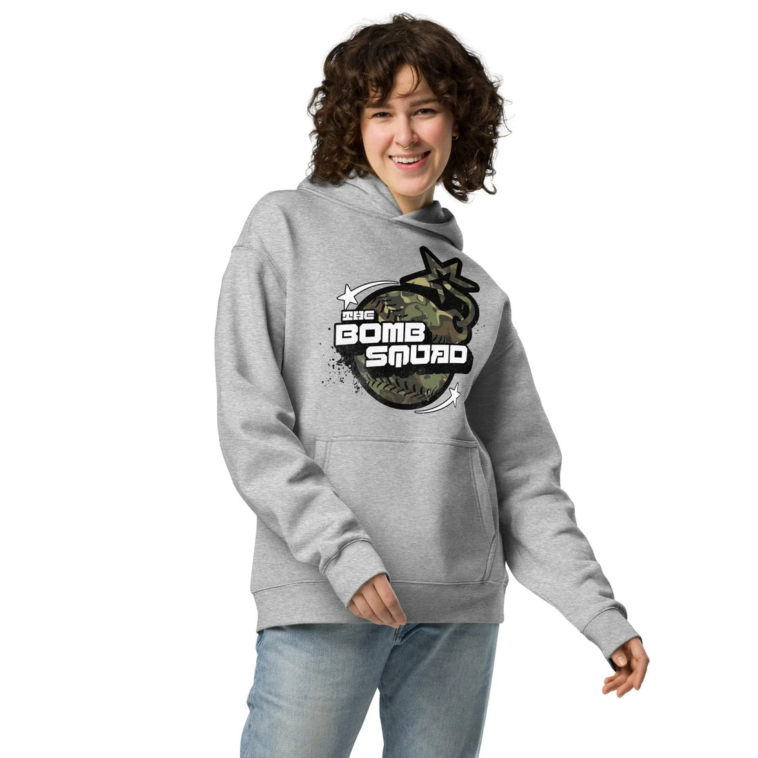 A gray oversized hoodie with a camouflage pattern on the front and 'BOMB SQUAD' text along with a graphic logo on the right chest area.
