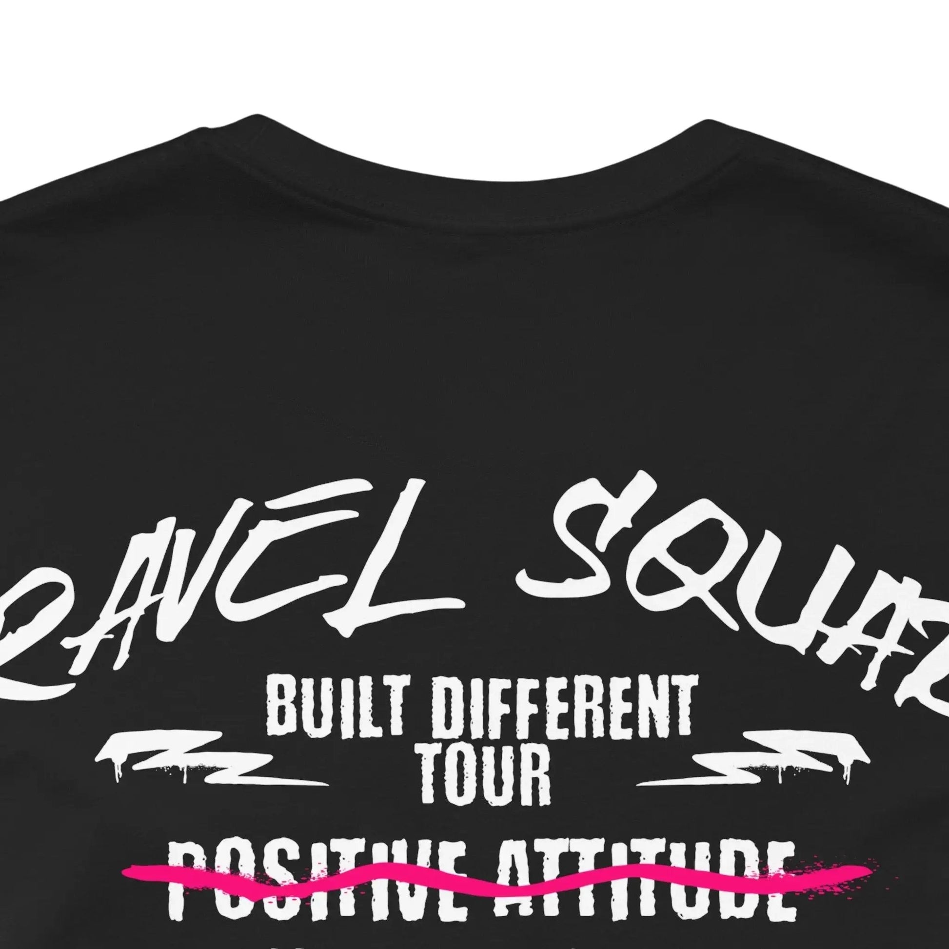 Black t-shirt with white text and a pink line on a white background