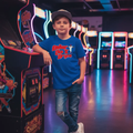 Professional baseball lifestyle photoshoot with Baller Like Bryce Youth Tee in arcade