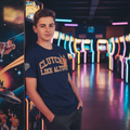 Professional baseball lifestyle photoshoot with Clutch Like Altuve Tee in arcade - teenage model