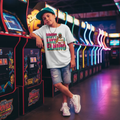 Professional baseball lifestyle photoshoot with Drippy Like El Nino Youth Tee in arcade