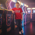 Professional baseball lifestyle photoshoot with Tough Like Trout Youth Tee in arcade